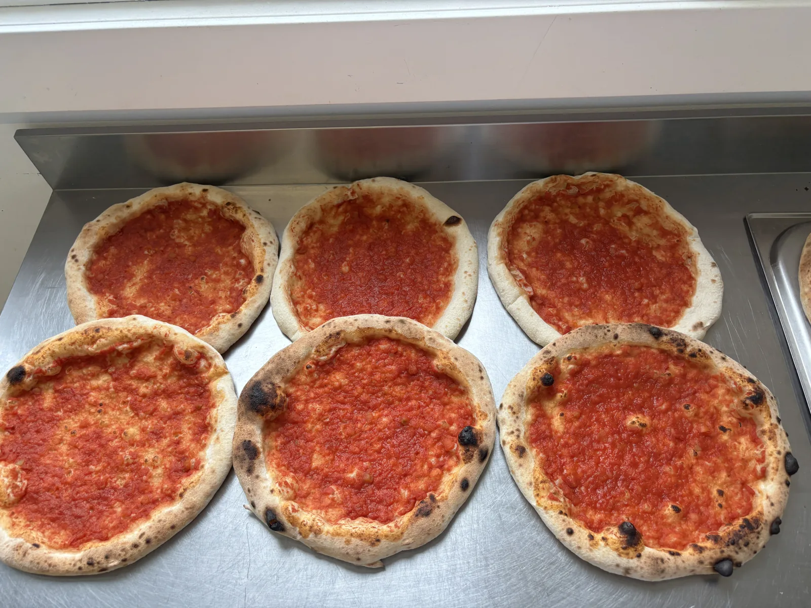 Trays of ready-to-bake Ferraro pizza bases topped with Italian tomato